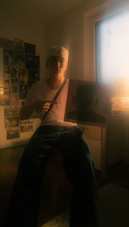 Happy customer holding a personalized volumetric piece in a cozy, art-filled room.