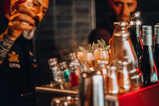 Close-up of a bartender expertly preparing a signature cocktail at a stylish mobile bar.