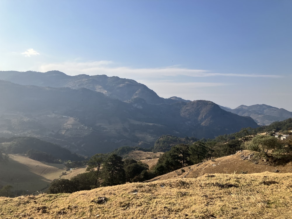 a view of the mountains from a hill top