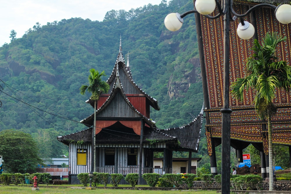 a large wooden building sitting next to a lush green hillside