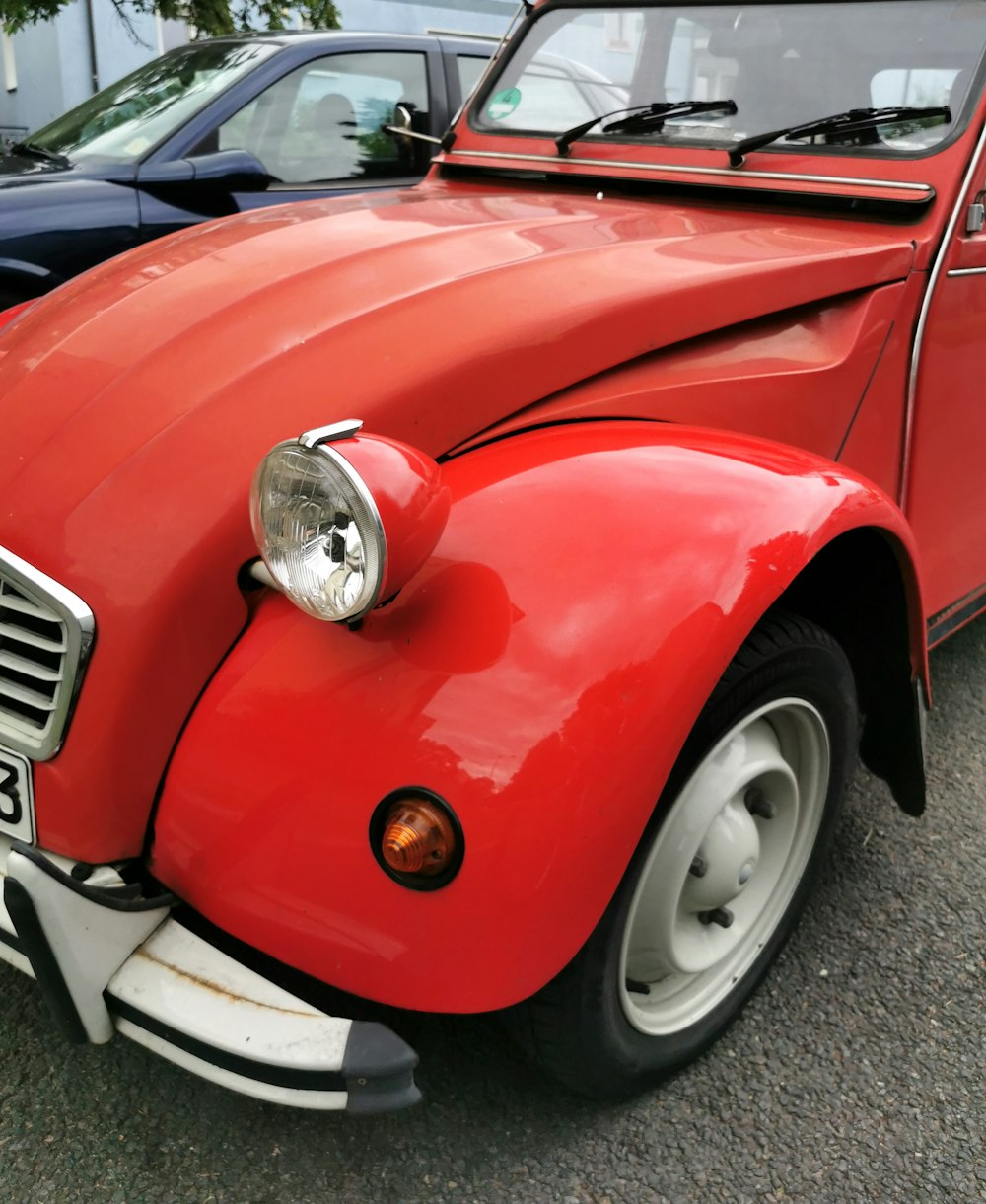 a red car parked next to a black car