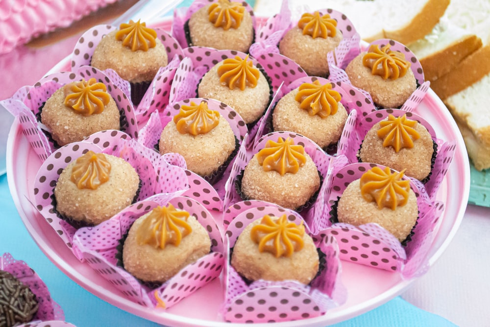 a plate full of cupcakes on a table