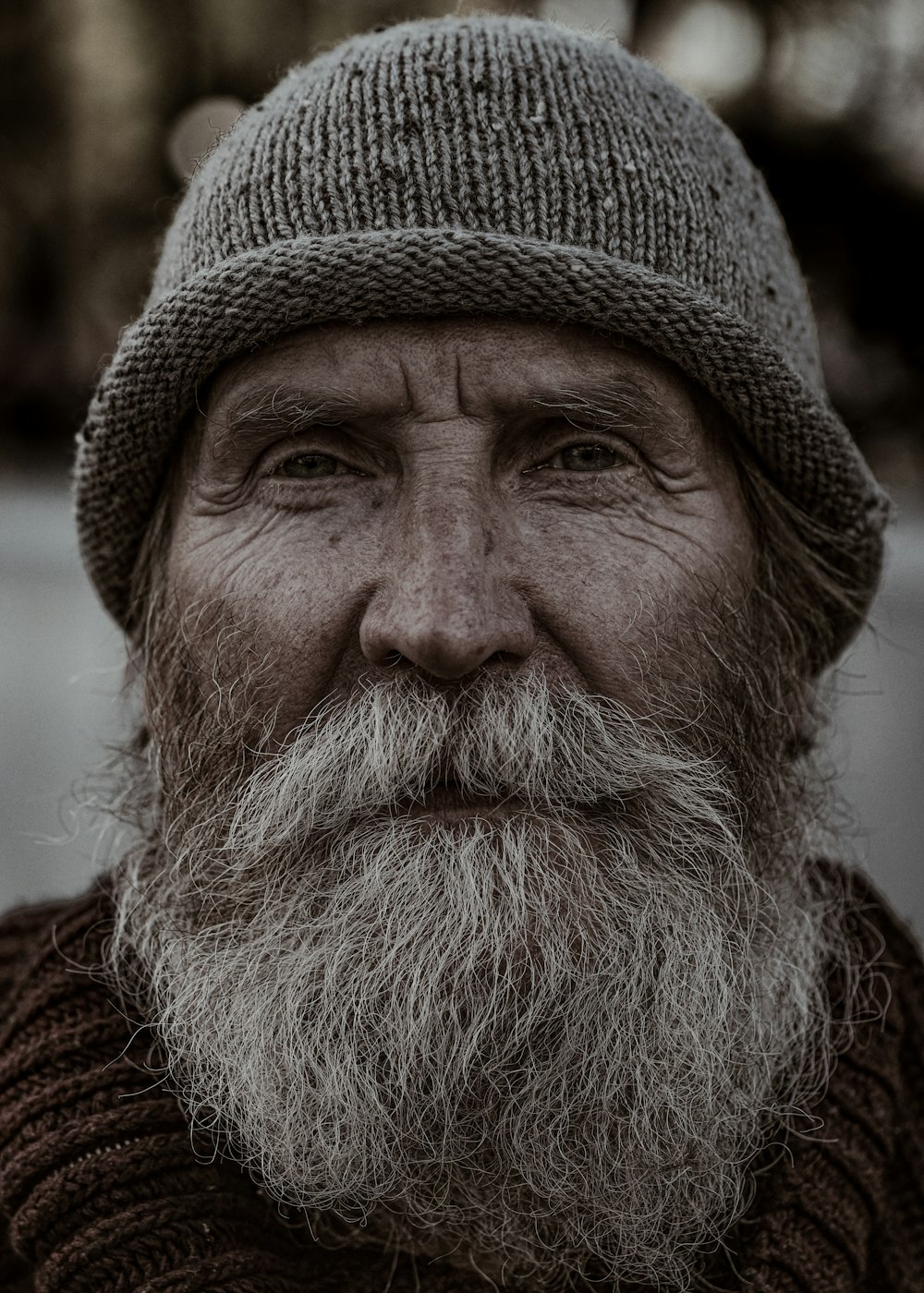 a man with a long beard wearing a hat