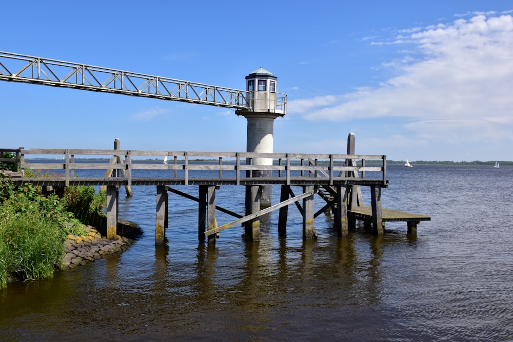 a light house sitting on top of a wooden pier