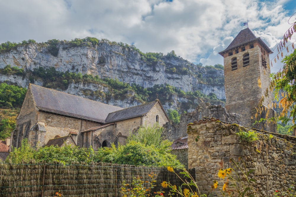 a stone church with a steeple in the background