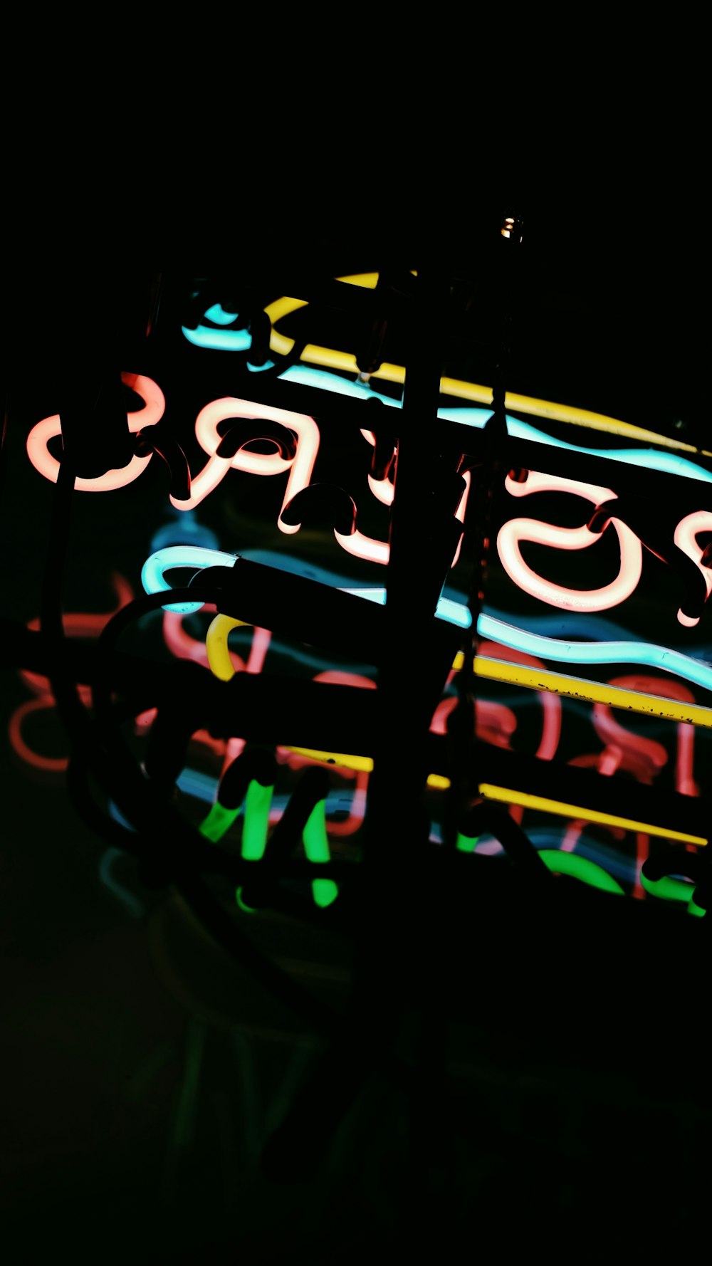 a close up of a neon sign in the dark