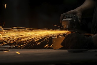 a person using a grinder on a piece of metal