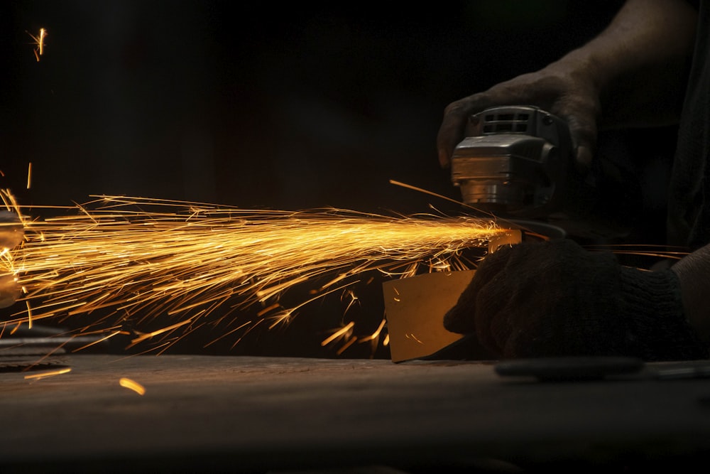 a person using a grinder on a piece of metal
