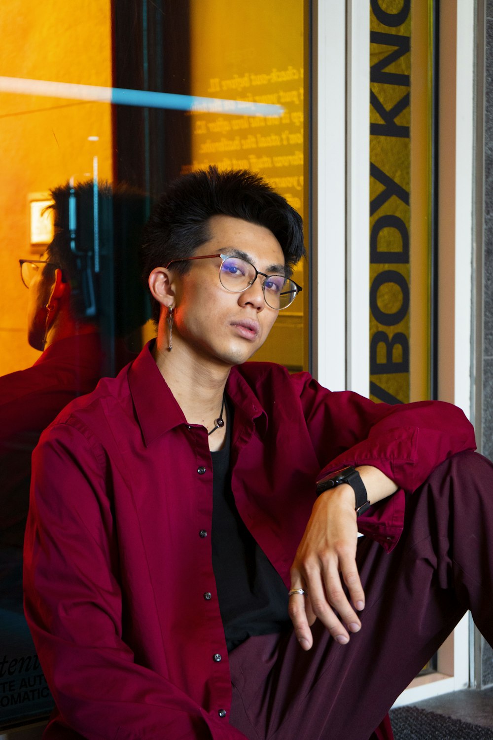 a man in a red shirt and purple pants