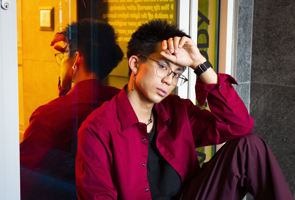 a man in a red shirt and black pants