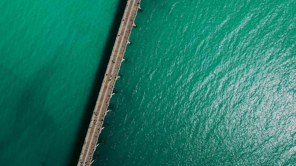 an aerial view of a bridge over a body of water