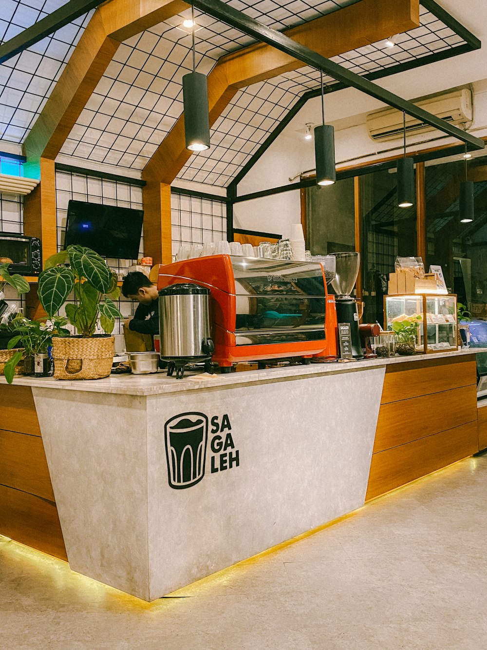 a restaurant counter with a large potted plant on top of it