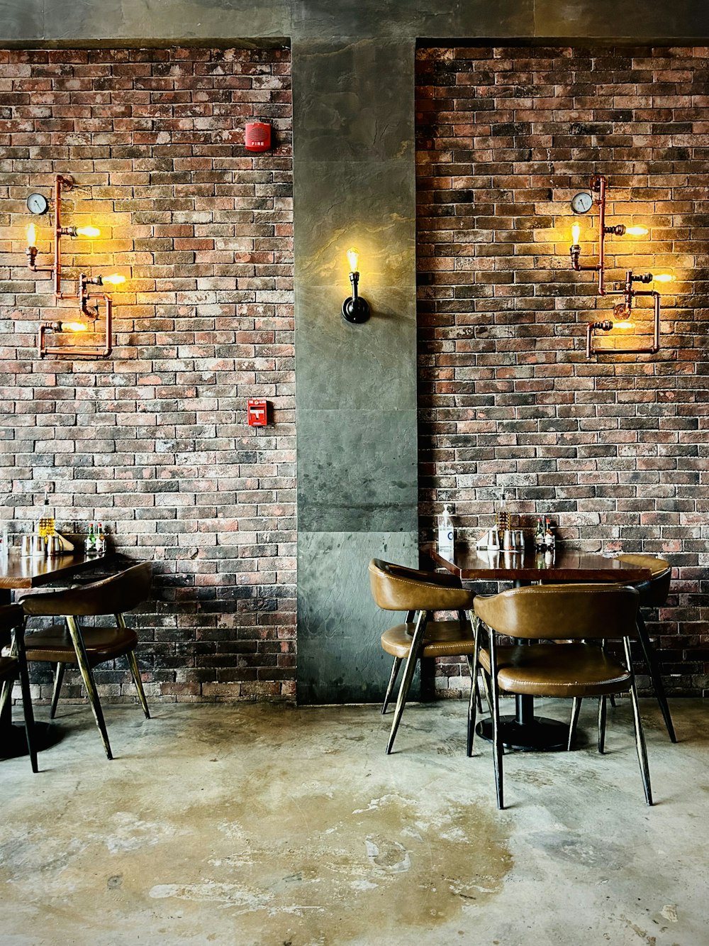 a restaurant with brick walls and wooden chairs