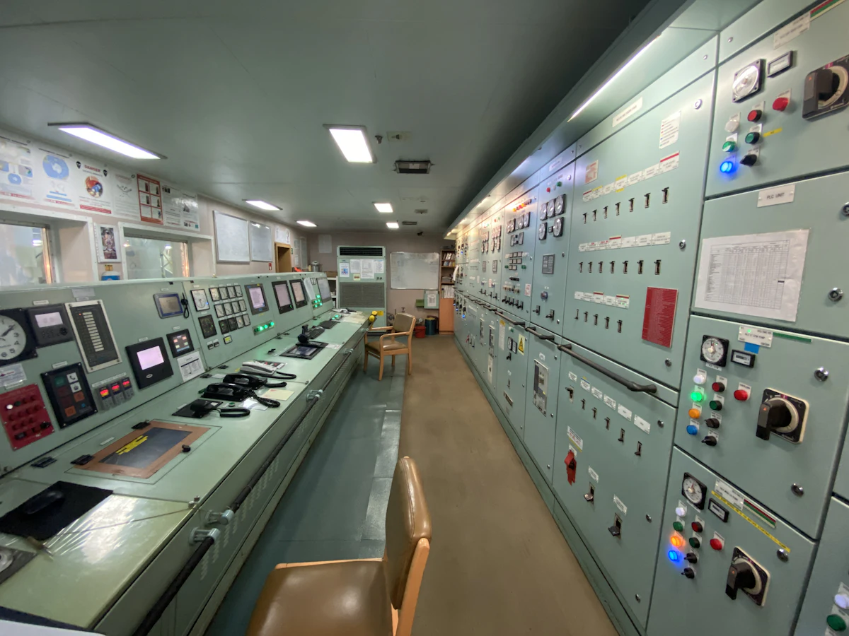 A dispatch control room lit by rows of monitors and communications equipment.