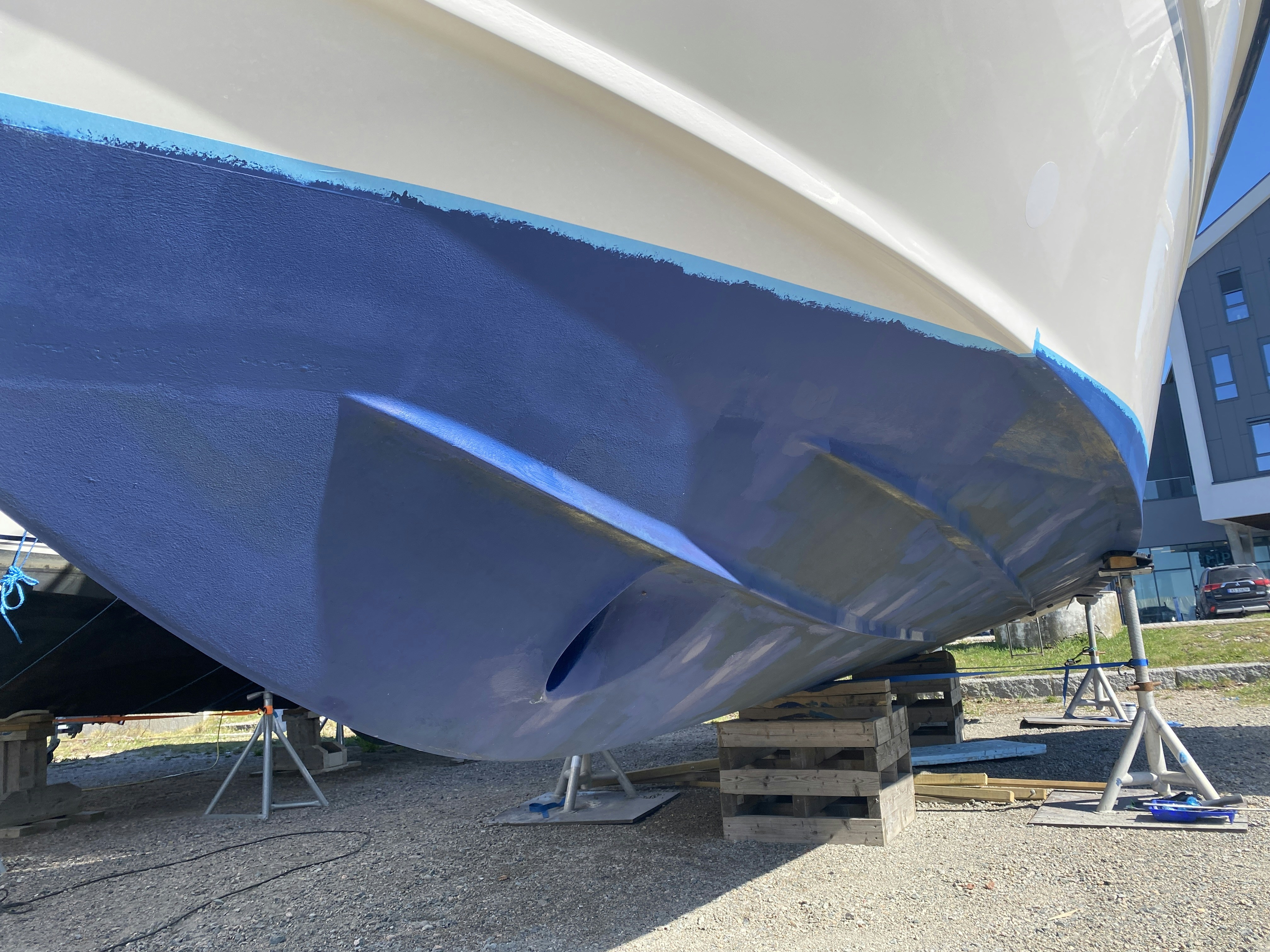 a blue and white boat being worked on