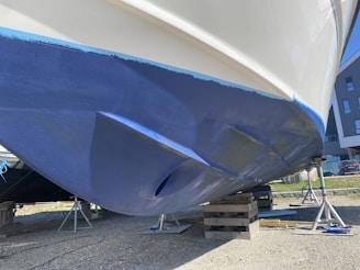 a blue and white boat being worked on