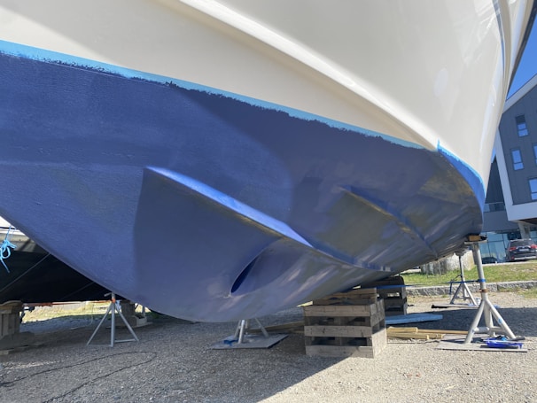 a blue and white boat being worked on