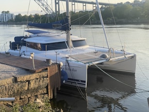 a catamaran docked at a dock in the water