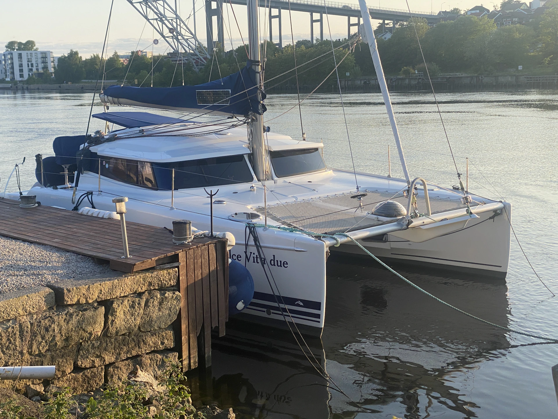 a catamaran docked at a dock in the water