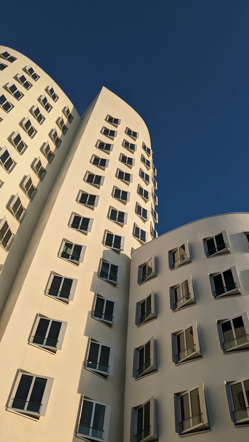 a tall white building with lots of windows