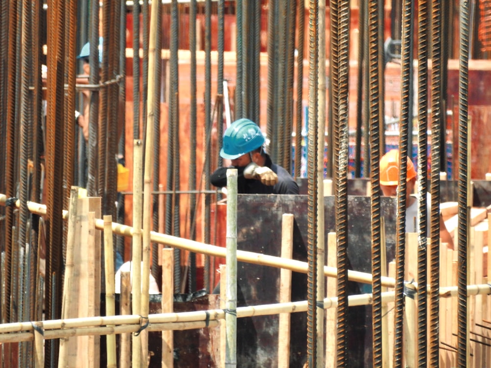 a man wearing a hard hat standing in front of a construction site