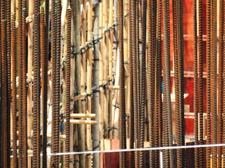 Close-up of sturdy TMT saria rods stacked at a residential construction site.