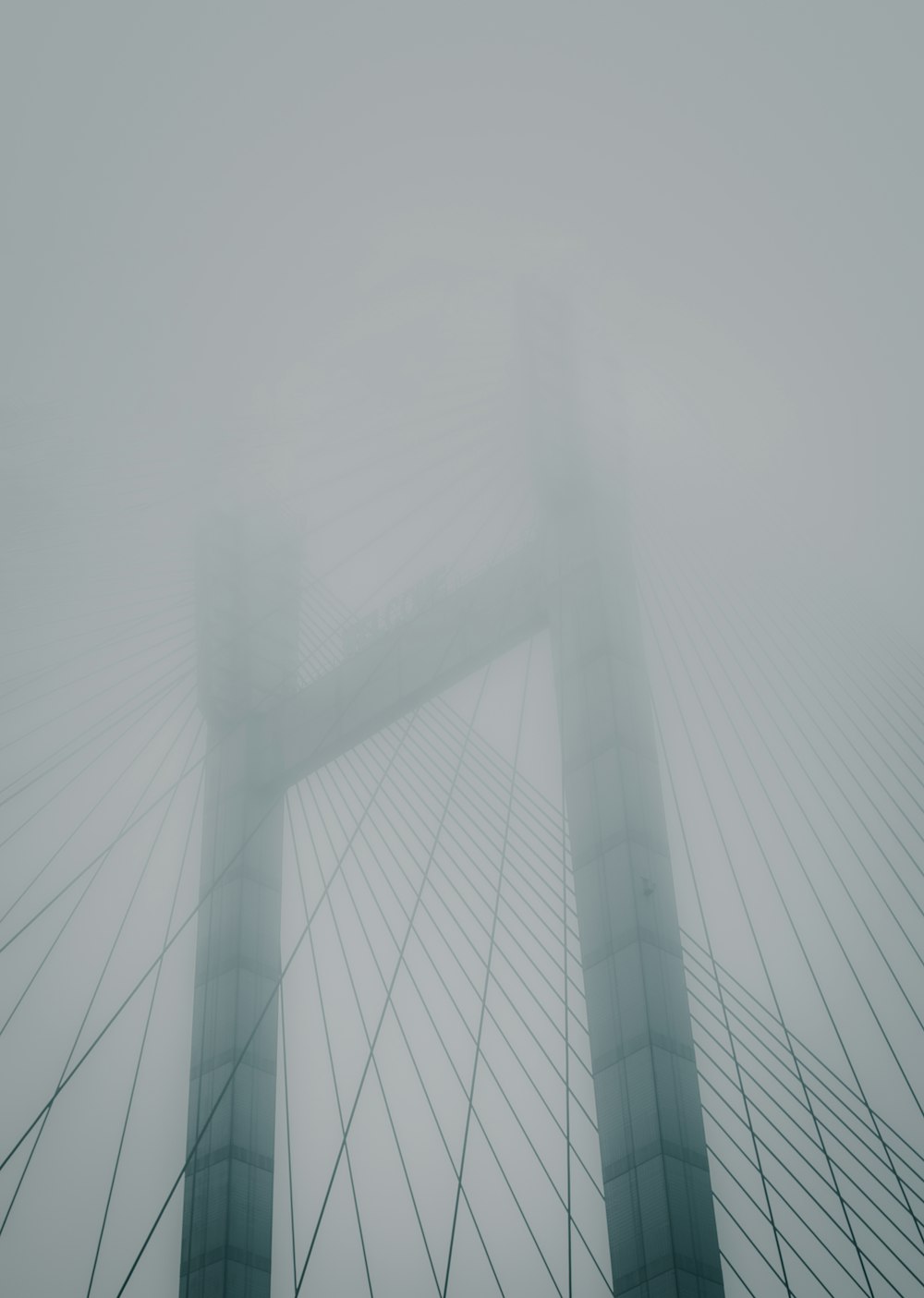 the top of a bridge in the fog