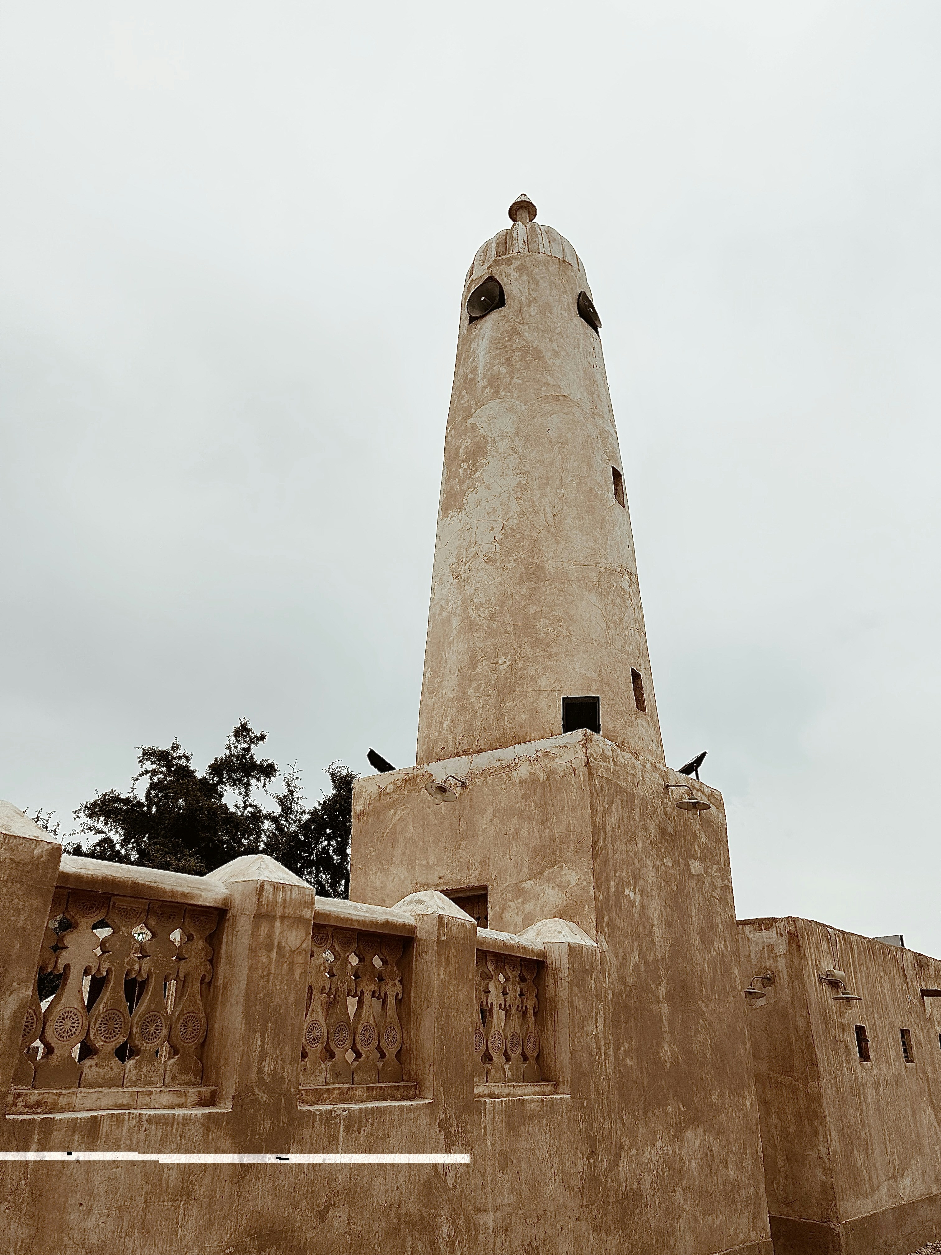 a very tall tower with a clock on it's side