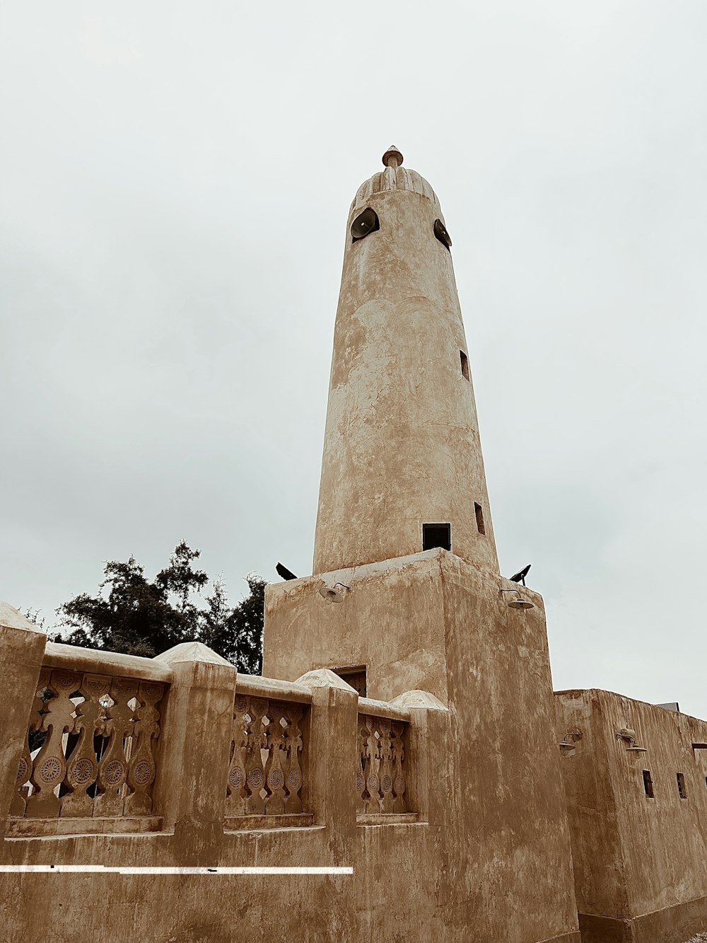 a very tall tower with a clock on it's side