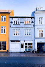 Close-up of colorful American and European window profiles displayed side by side.