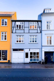 Close-up of colorful American and European window profiles displayed side by side.
