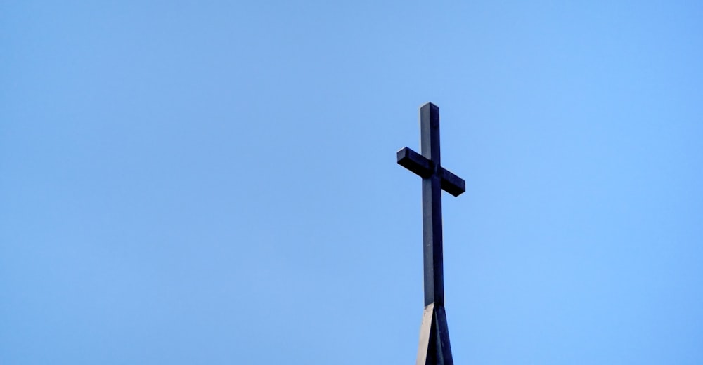 a cross on top of a building against a blue sky