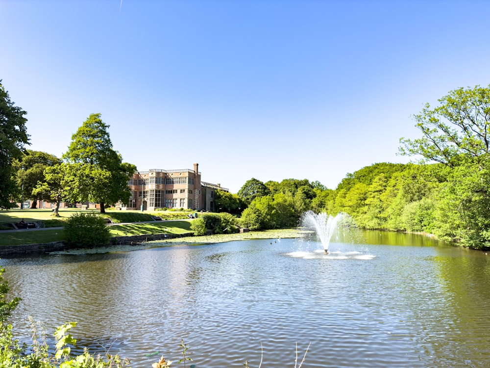 a pond with a fountain in the middle of it