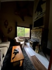 Inside view of cabin living room with rustic wooden furniture and fireplace