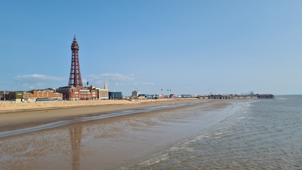 a view of a beach with a tower in the background