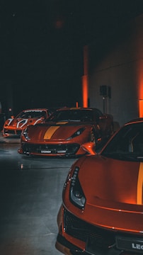 a row of sports cars parked in a parking lot