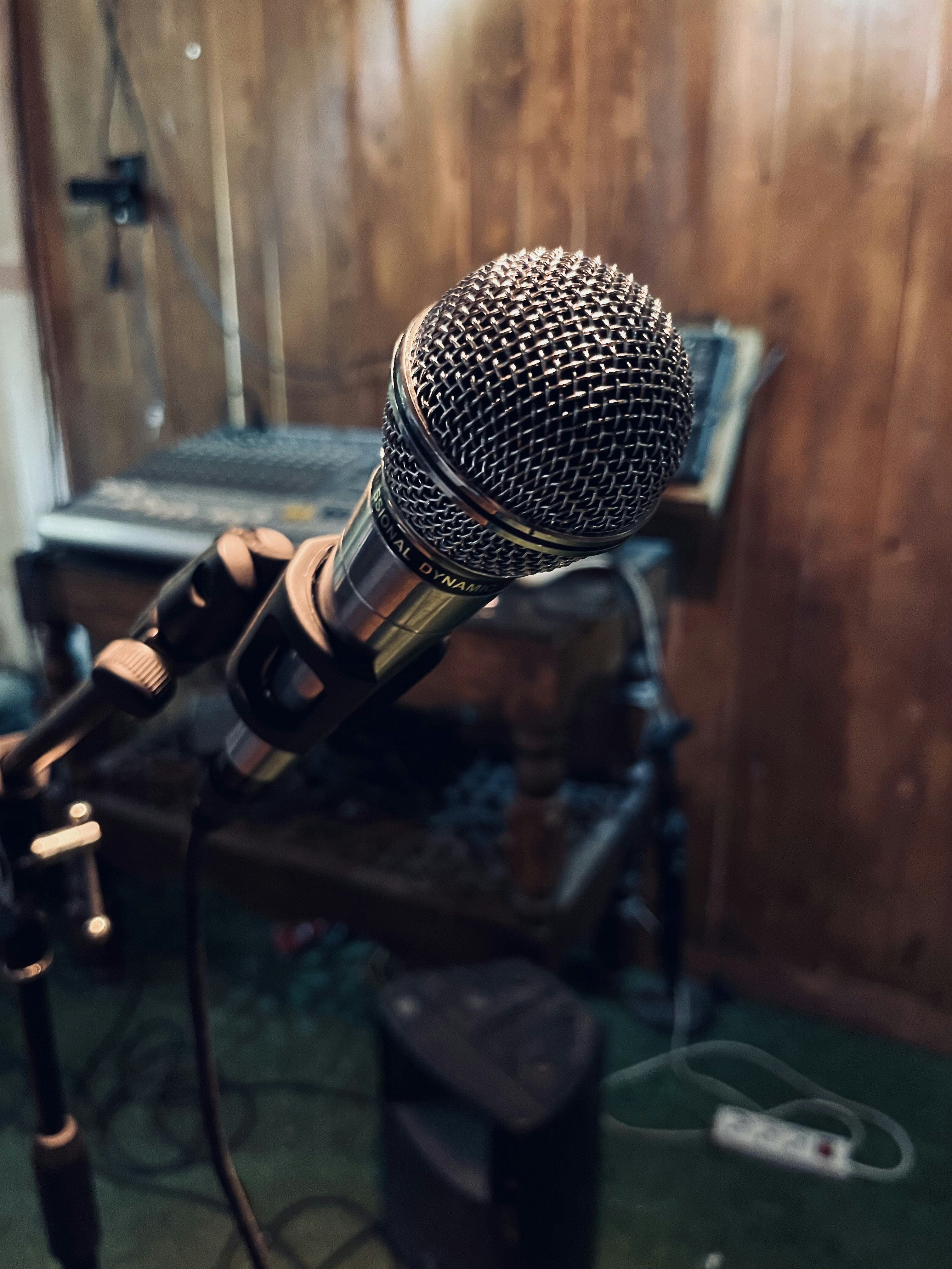 a microphone in front of a wooden wall