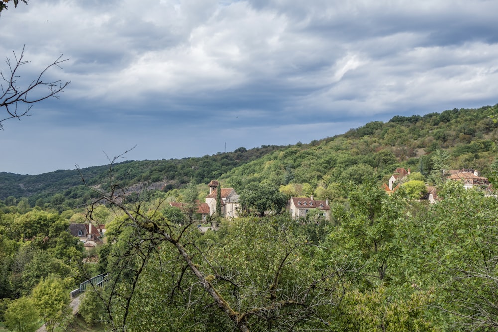 a scenic view of a village nestled on a hillside