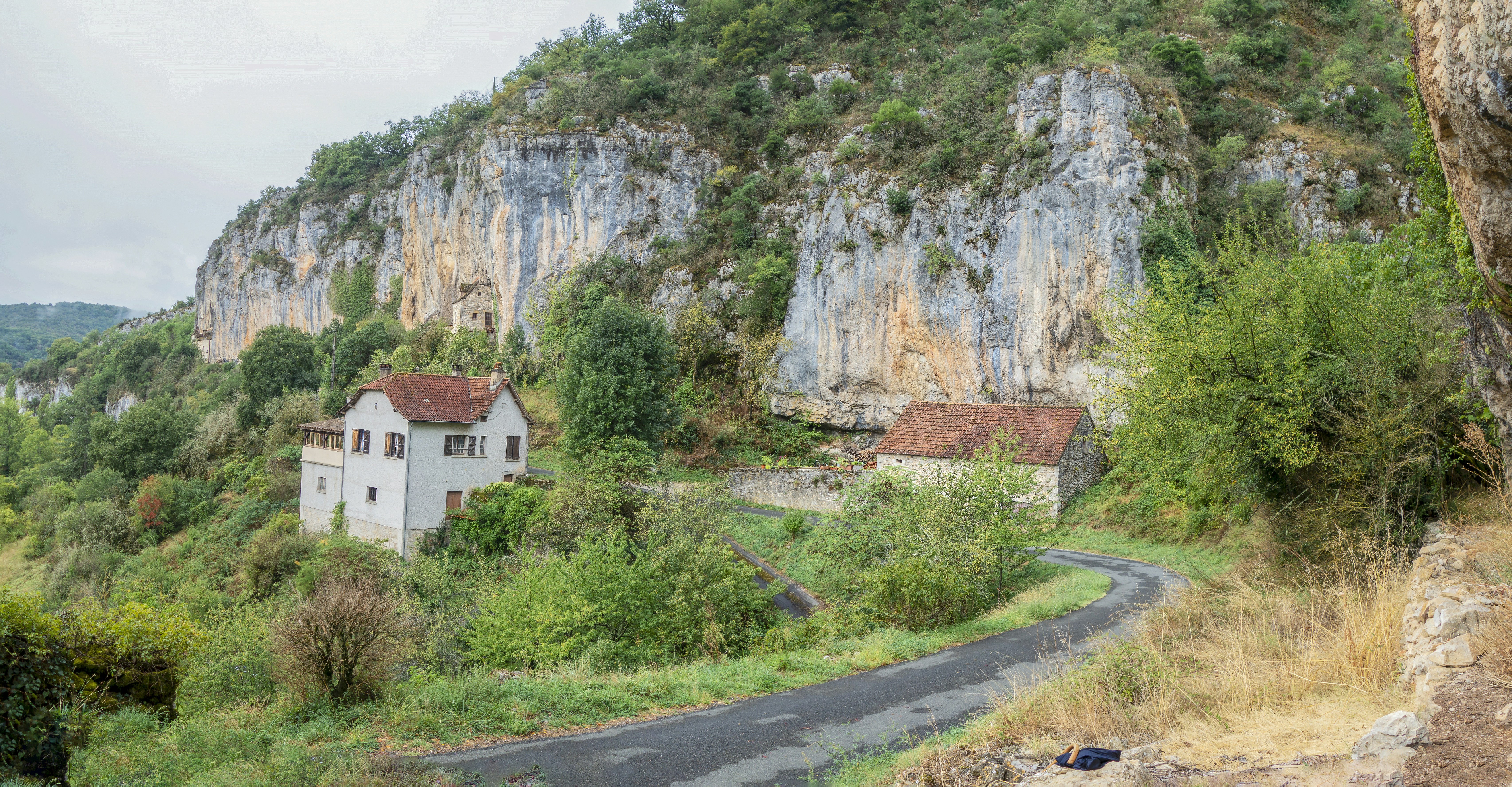 a house on the side of a mountain road