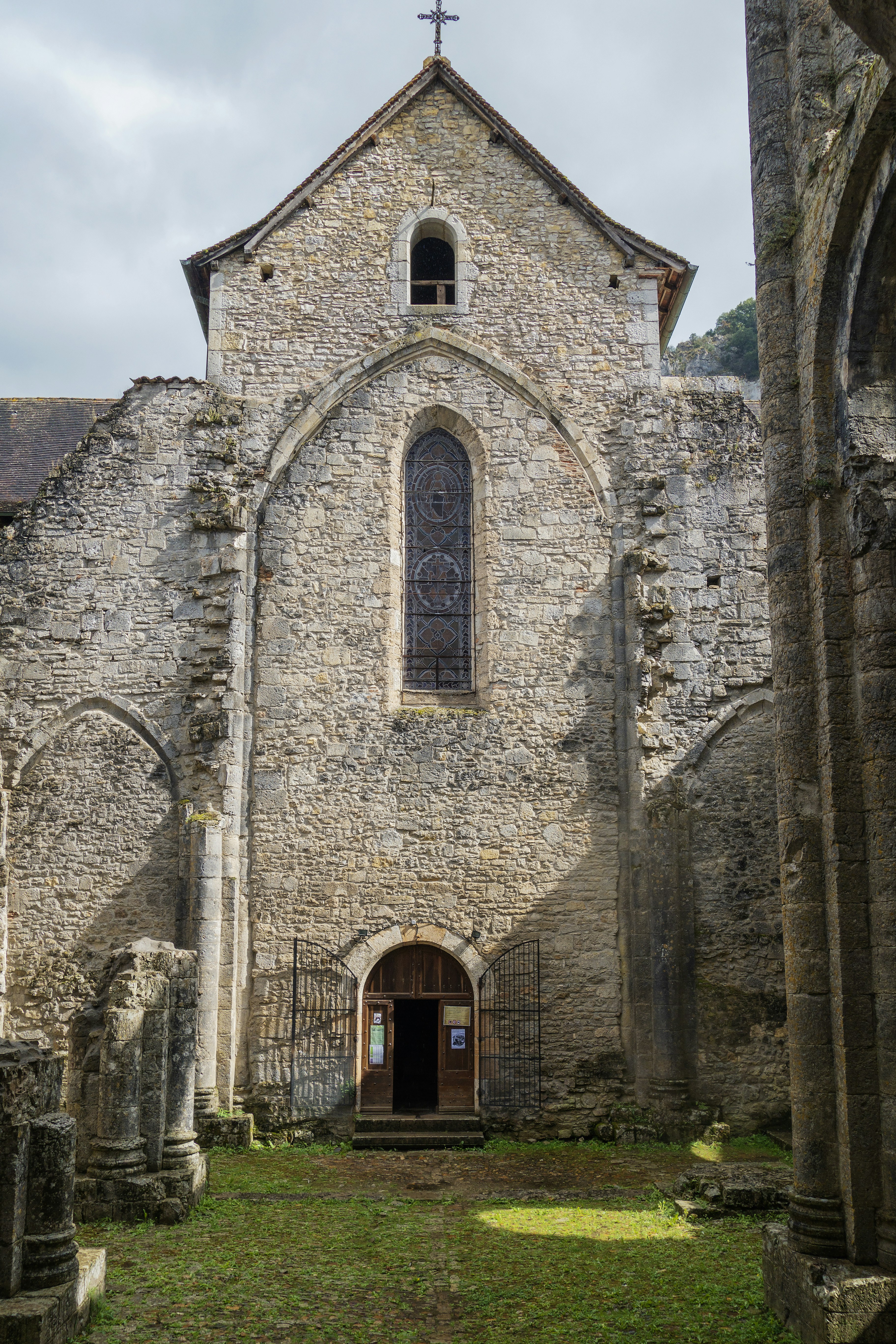 a stone church with a cross on the top of it