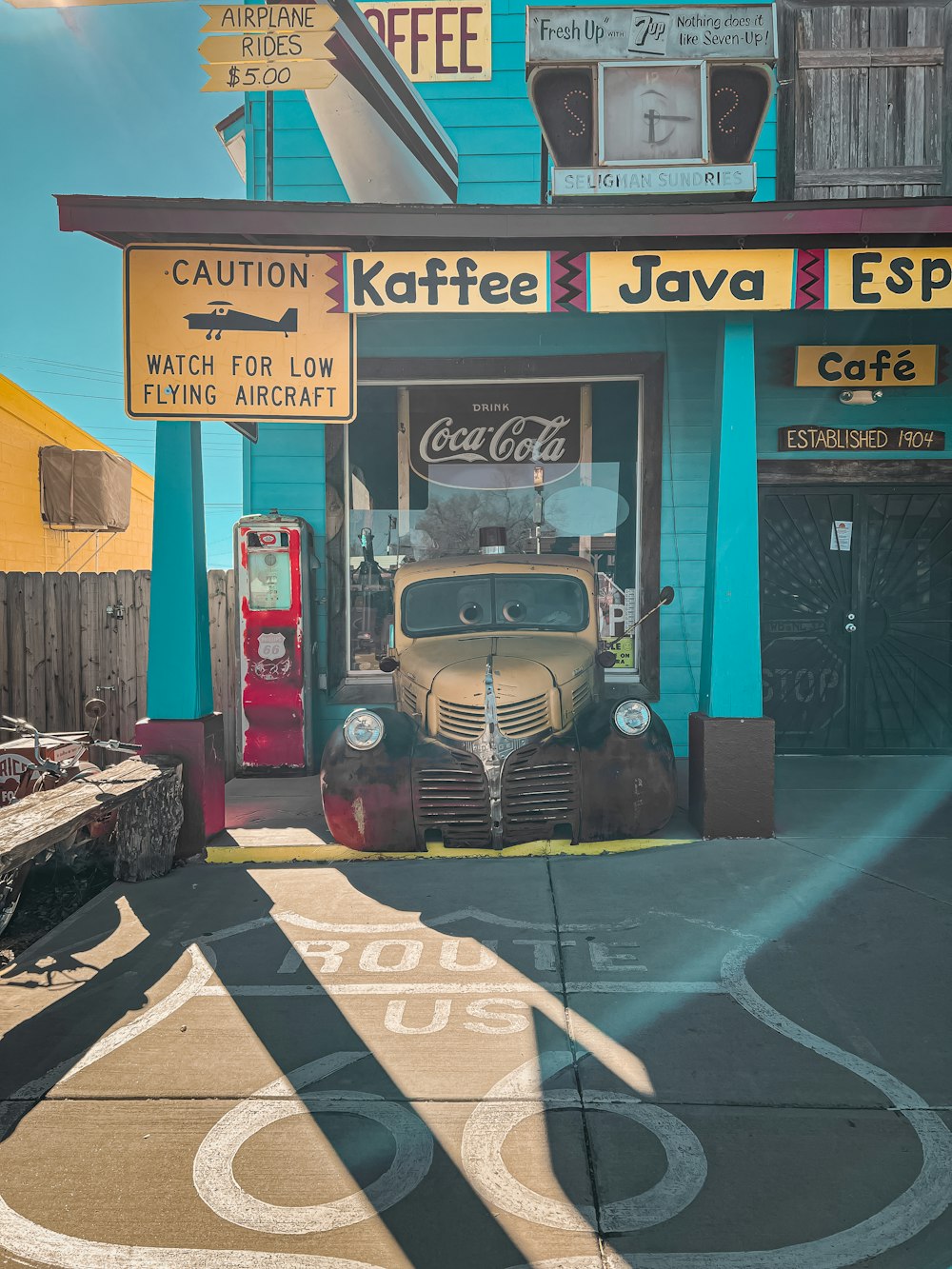 a vintage car is parked in front of a coffee shop