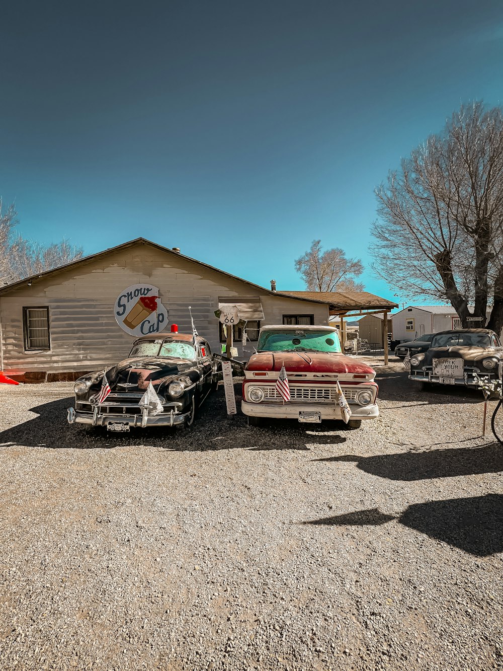 a couple of old cars parked in front of a building