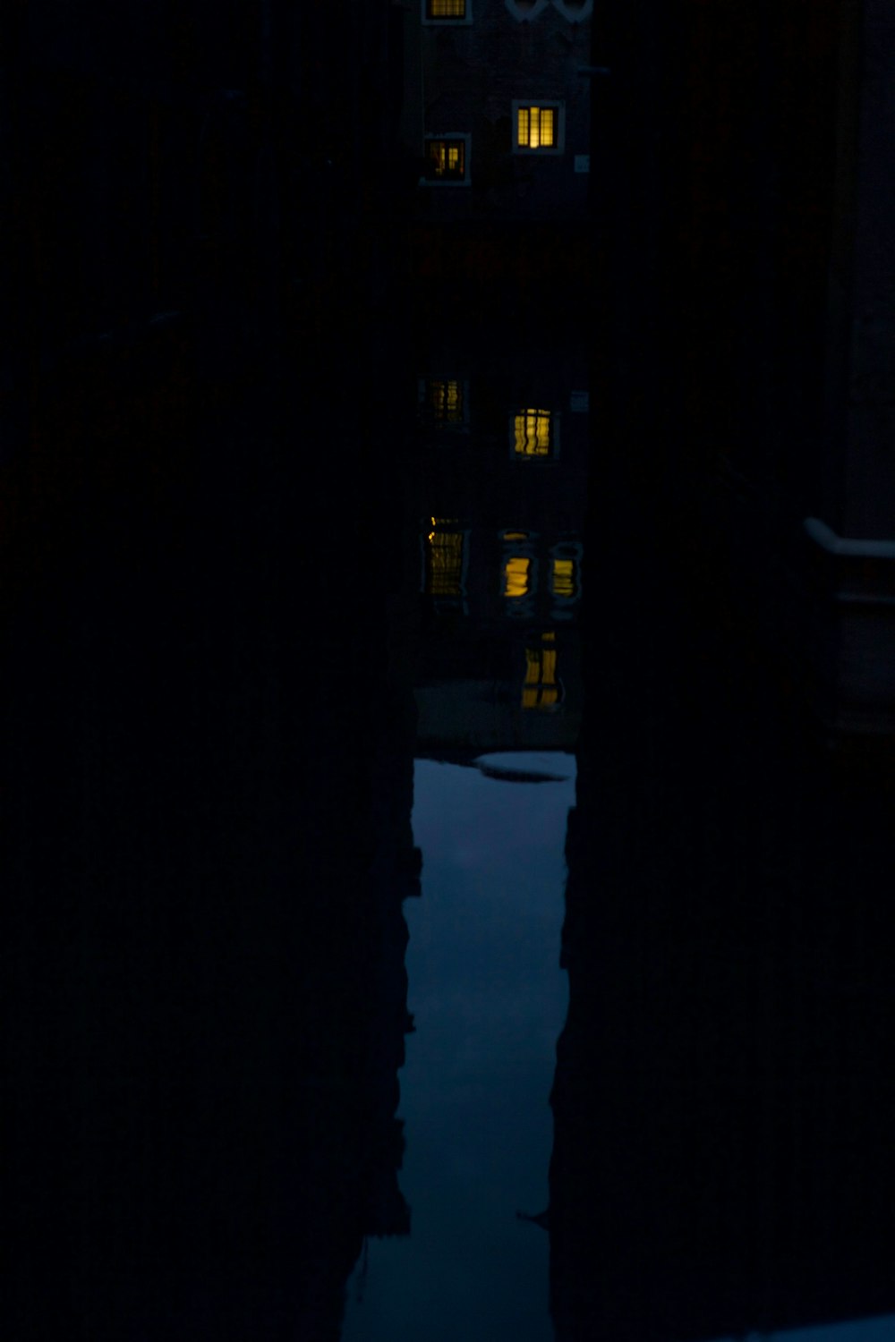 a reflection of a building in a body of water