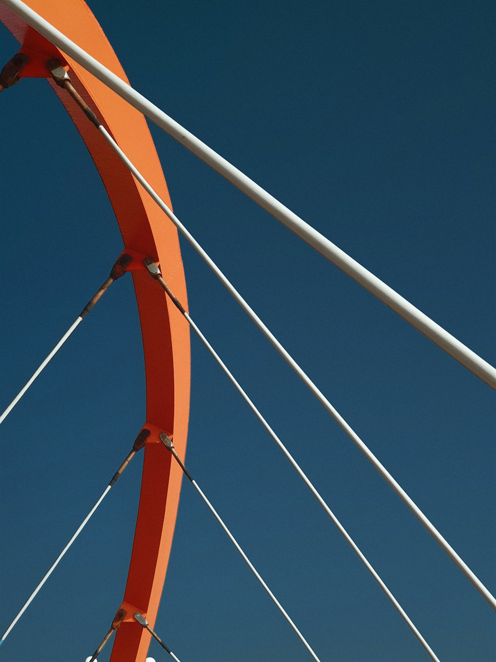 a close up of a red bridge with a blue sky in the background