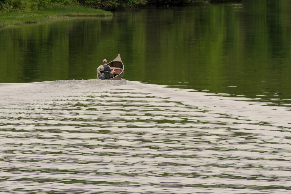 a person riding a boat on a body of water