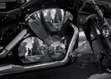 A close-up of a motorcycle's chrome engine reflecting sunlight.