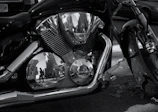 Close-up of Yamaha FZ’s engine with Bogotá skyline in background.
