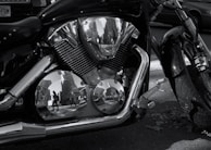 A close-up of a motorcycle's chrome engine reflecting sunlight.