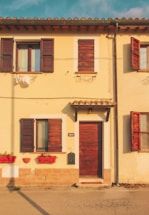 A cozy Spanish home with a welcoming front door and a mailbox nearby.
