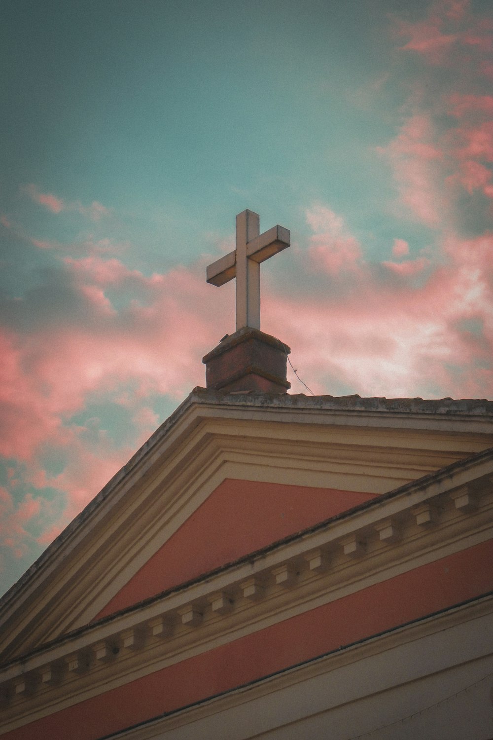 a church steeple with a cross on top of it